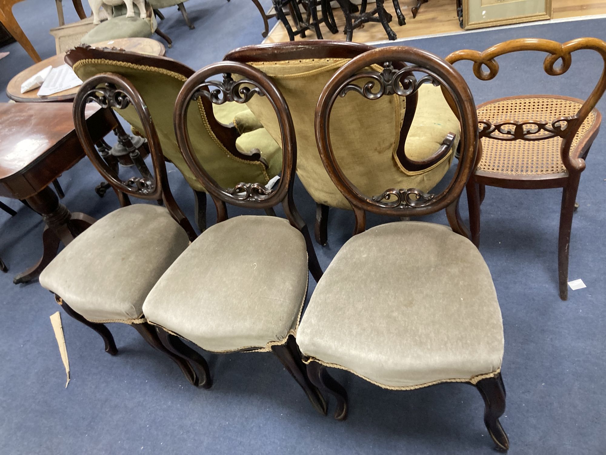 A Victorian mahogany open armchair, a Victorian nursing chair, five balloon back dining chairs and a caned chair